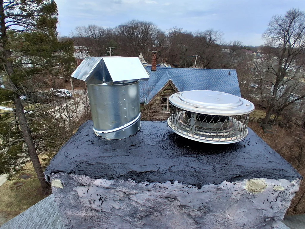 Chimney crown with a fresh sealant coat and two new flue caps