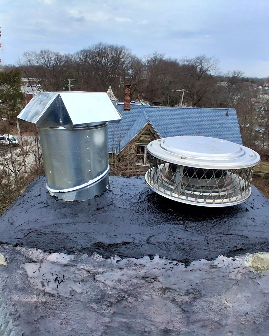 Chimney crown with a fresh sealant coat and two new flue caps